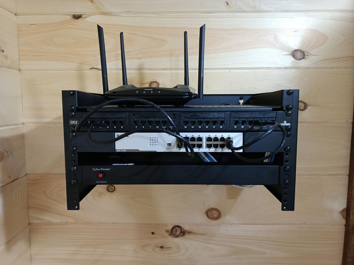 Professional network rack installation with patch panels, switch, router, and power management by Netwire PC