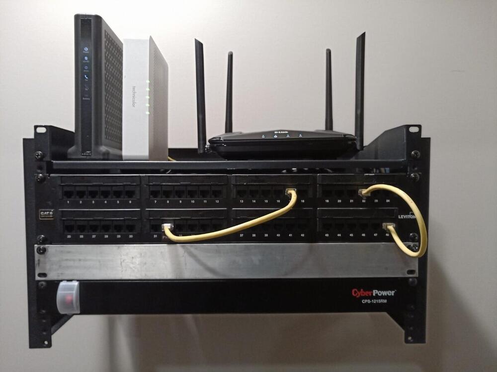 Completed home network rack with Cat6 patch panels router modem and CyberPower UPS battery backup